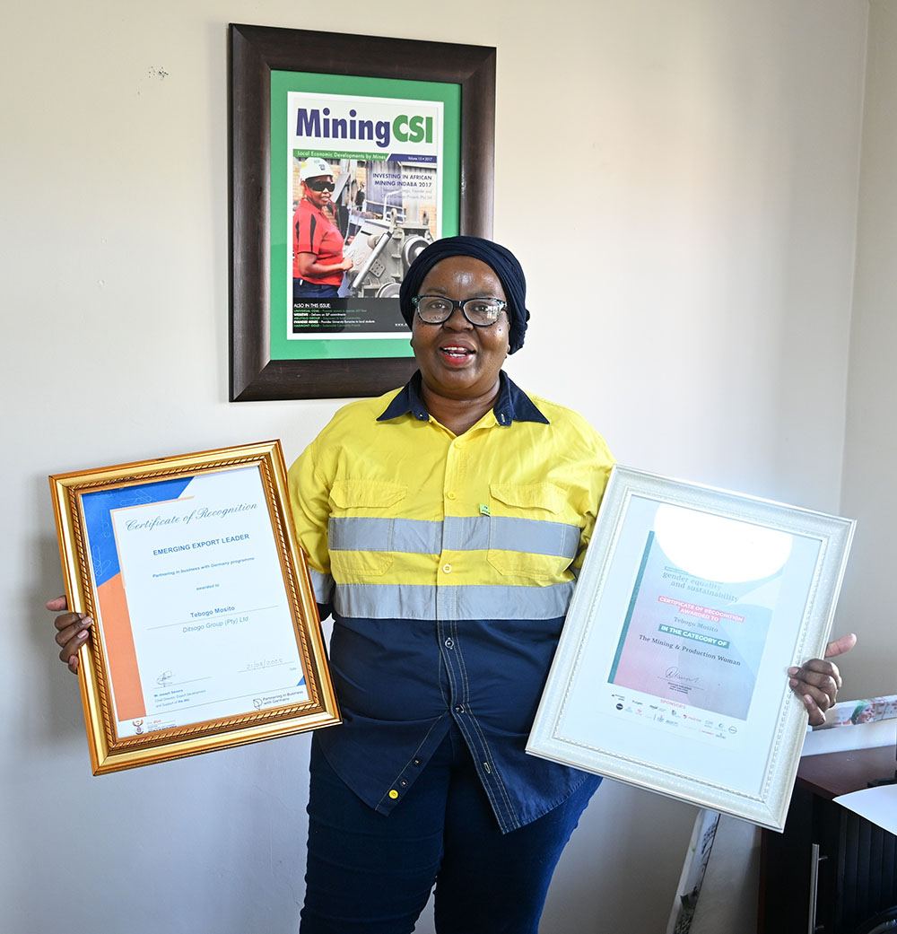 Ditsogo Group leadership with framed awards and certificates of recognition